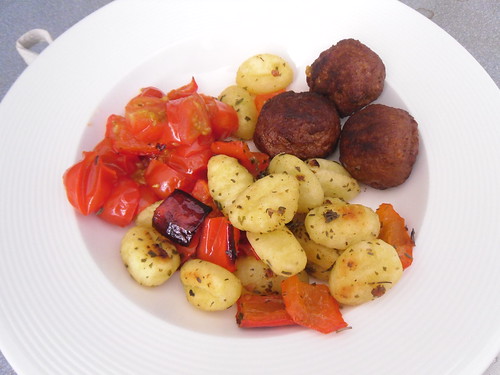 Baked Gnocchi with red bell pepper and tomatoes close up
